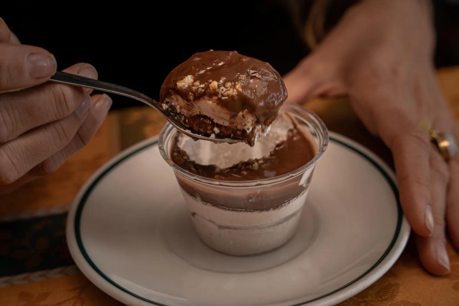 A chocolate mousse dessert glass being served at the restaurant stop
