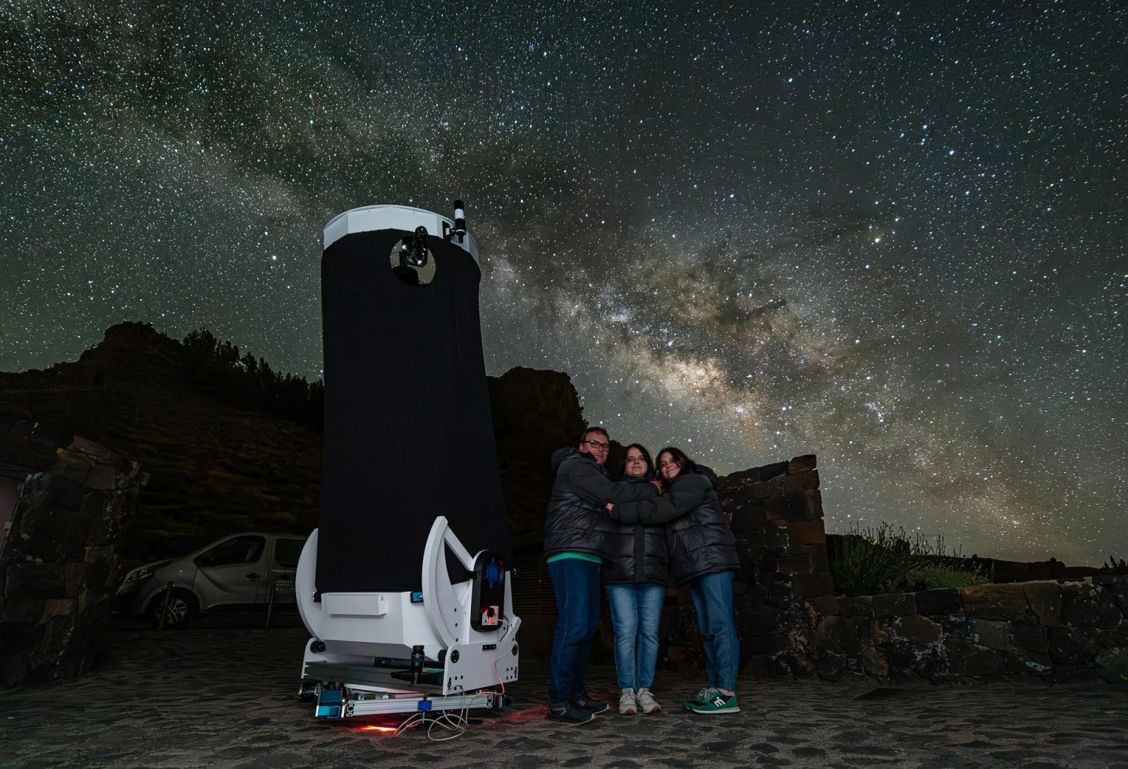 The 32-inch telescope and a family beneath the Milky Way at the observing site