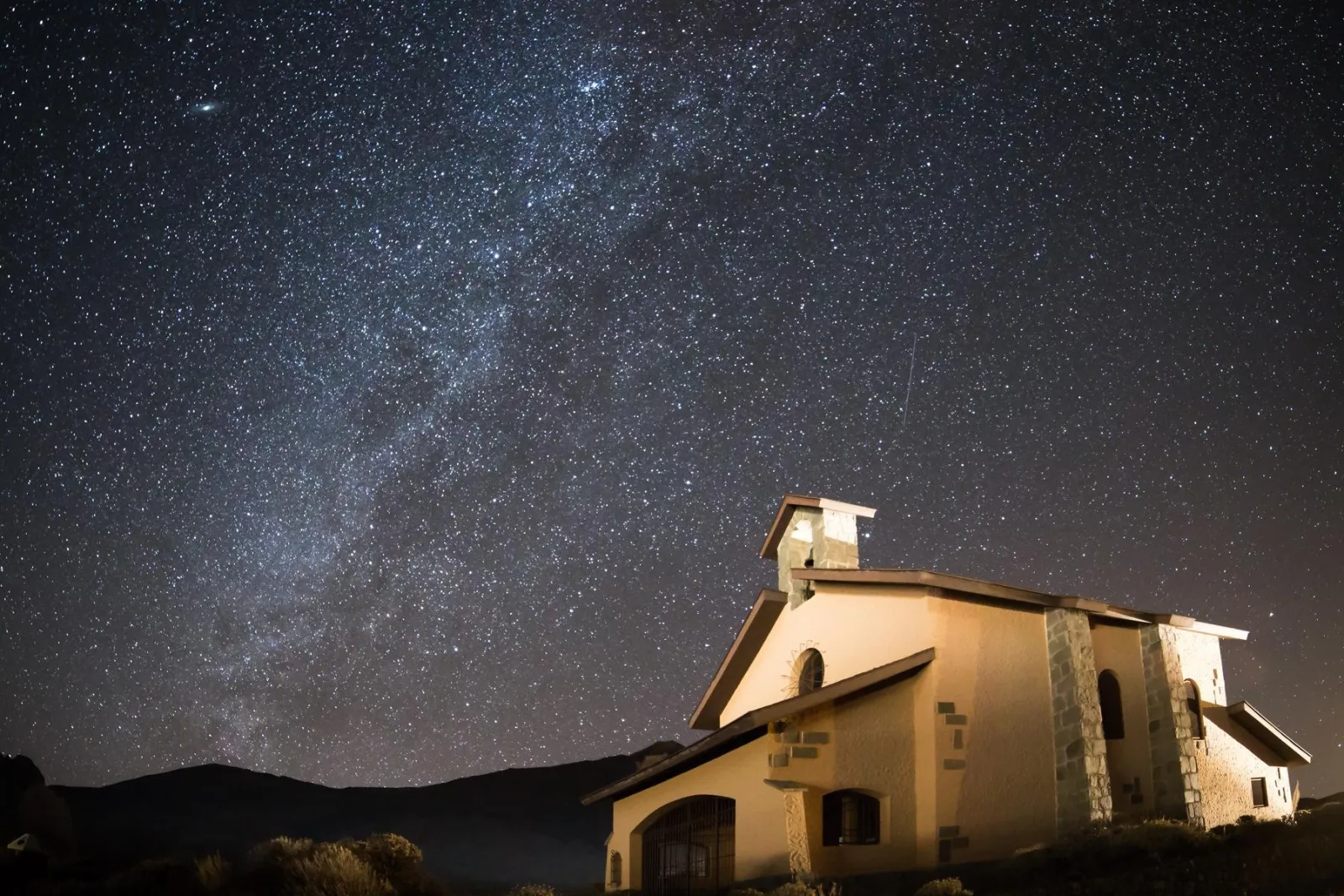 The Milky Way rising above the whitewashed Ermita de las Nieves chapel